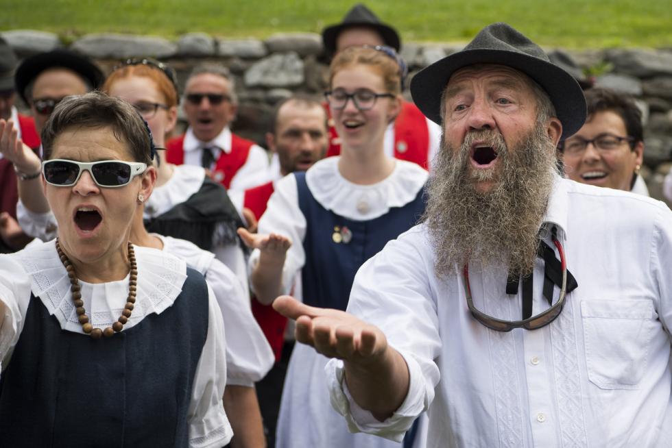 Men and women yodeling in traditional clothes