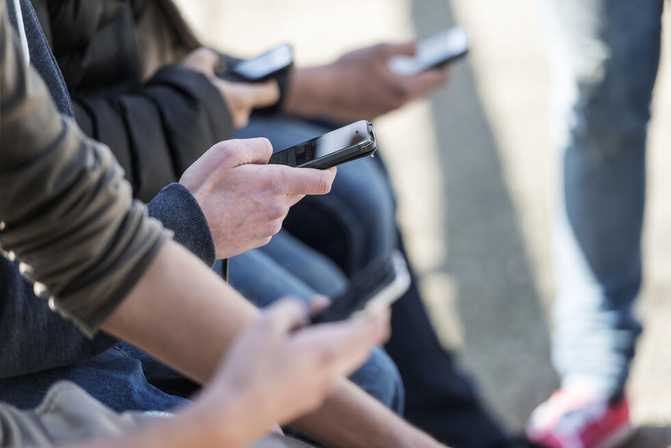 People hold their smartphones in their hands