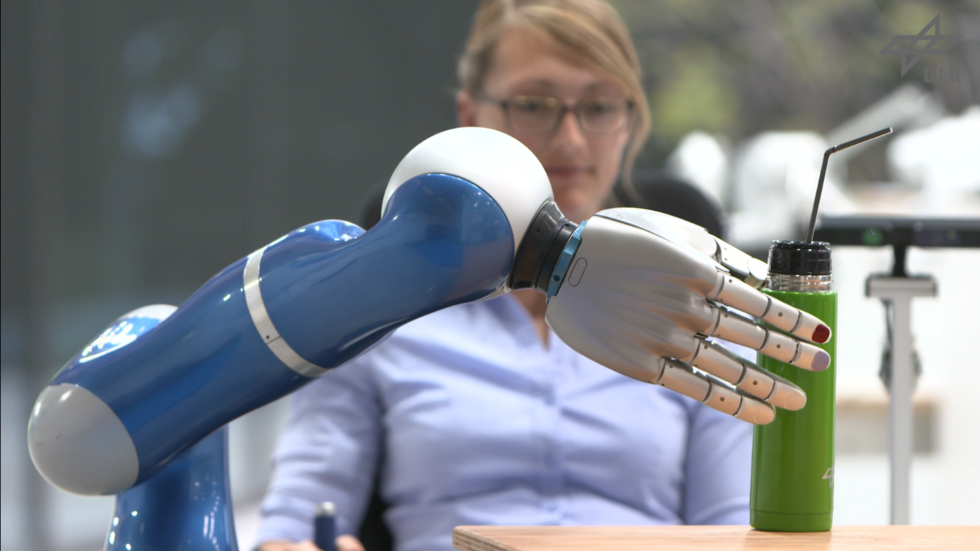 SMiLE robot holding a drink bottle