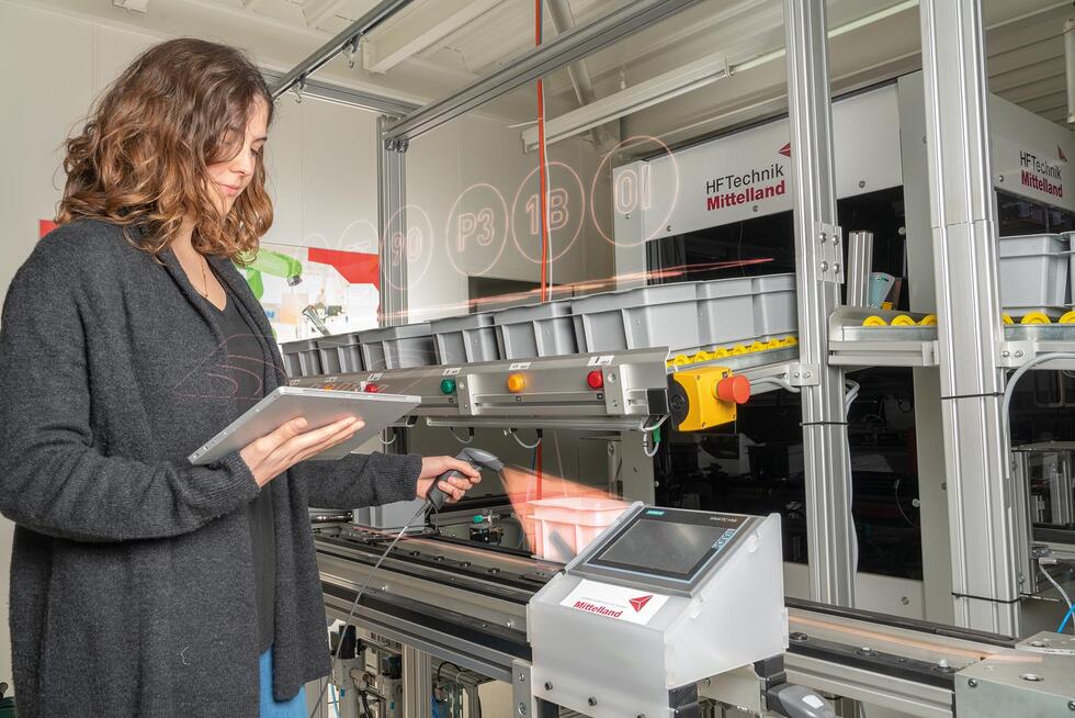 A woman with a laptop and a scanner