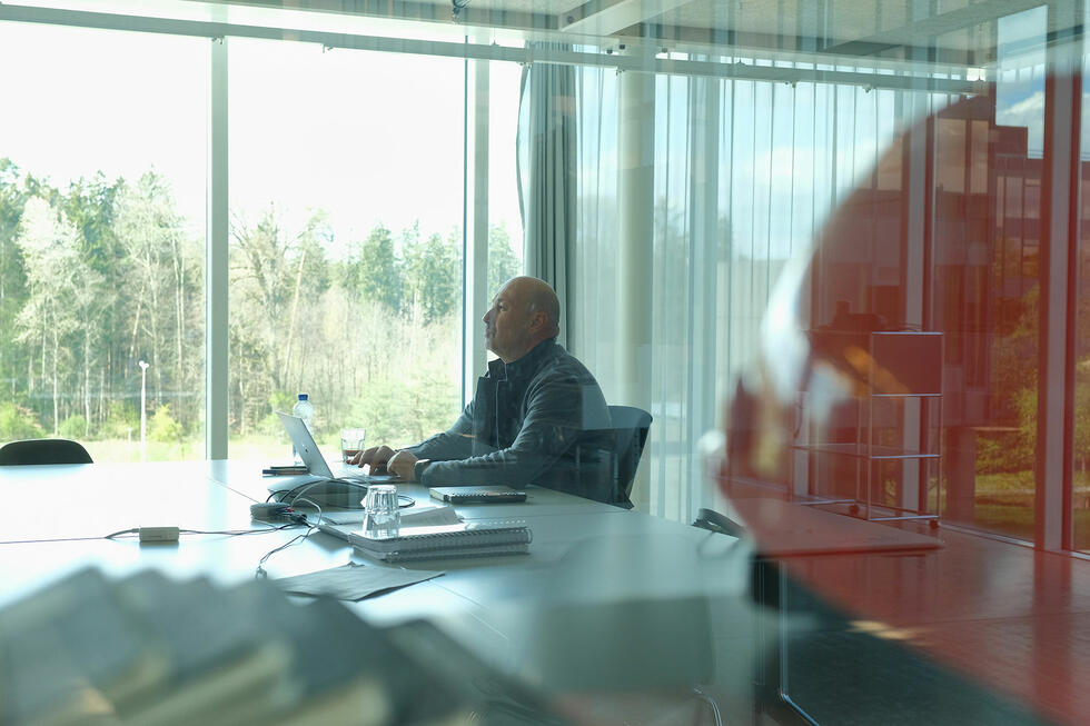 Sacha Menz sitting and working at his desk