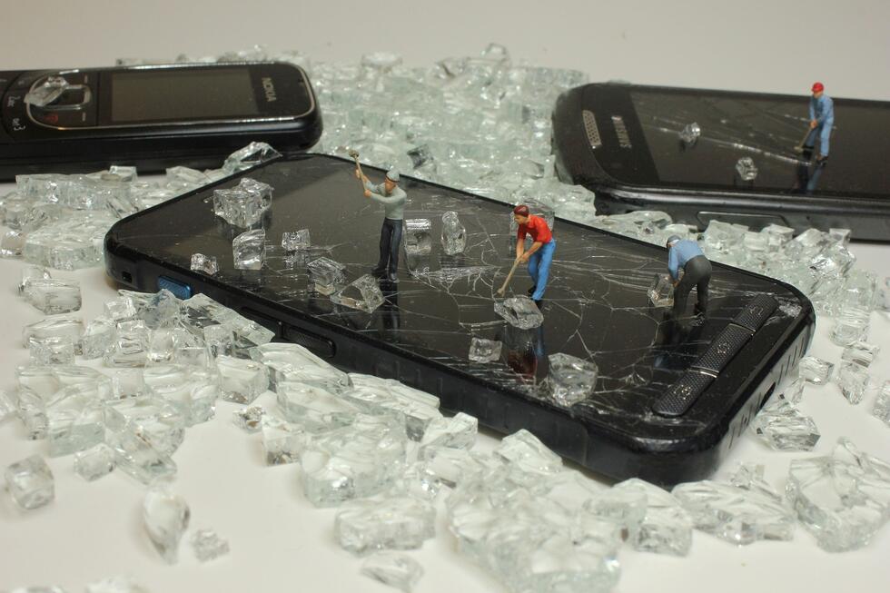 an image of broken smartphones about to be recycled