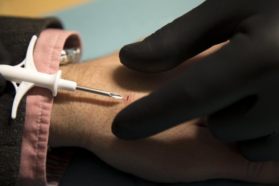 A picture made available on 04 March 2017 of David Holecek (L) getting a chip implanted in his hand by Jowan Osterlund of the company Biohax, in Gothenburg, Sweden, 02 December 2015.