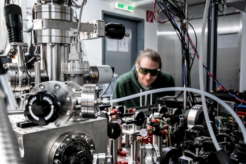 Man working at the experimental setup in laboratory