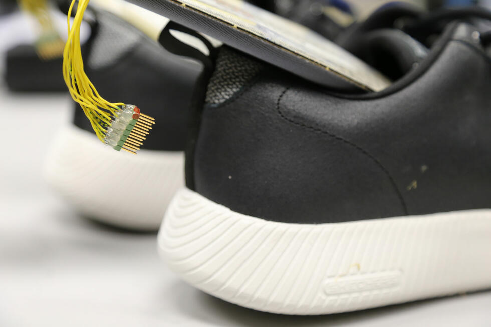 A pair of shoes with sensors attached