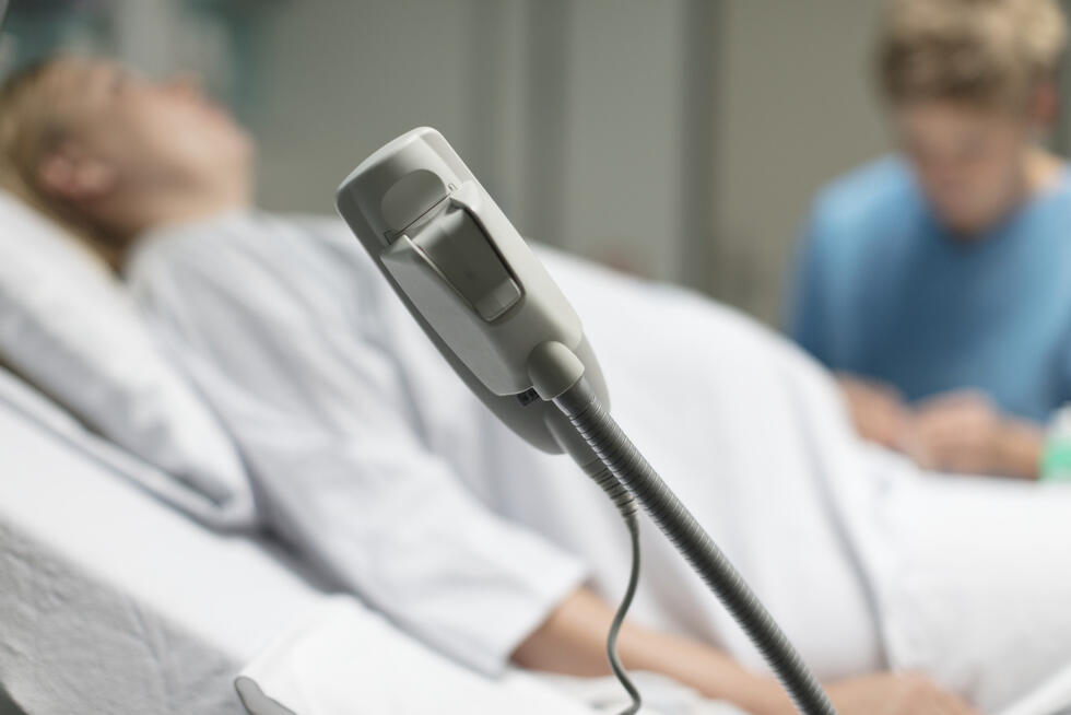 A woman lying on a hospital bed